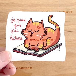 sticker en vynil blanc brillant avec un chat sur un livre ©2026 www.nadejart.fr